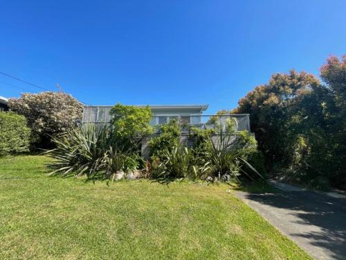 a house with plants in the yard at Oneroa 5 Star Views and Location I - Waiheke Escapes in Blackpool