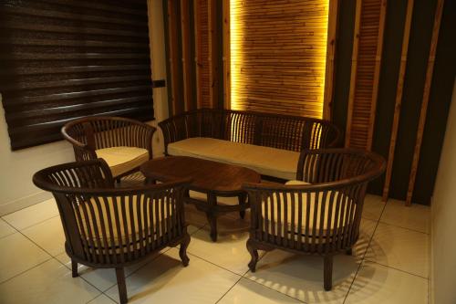 a table and four chairs and a table and a table and chairs at Vythiri Village in Vythiri