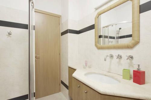 a bathroom with a sink and a mirror at FamilyBed Roma Monteverde-Vaticano in Rome