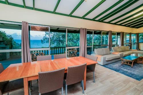 a dining room with a table and chairs at Endeavour - Rustic Two-Bedroom Home With Stunning Ocean & 1770 Headland Views in Seventeen Seventy