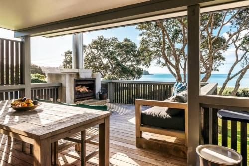 a deck with a table and a fireplace at ONEROA BEACHFRONT - Coast and Country in Blackpool