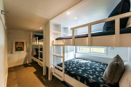 a room with three bunk beds in a house at ONEROA BEACHFRONT - Coast and Country in Blackpool