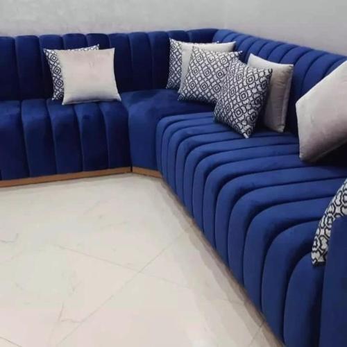 a blue couch with several pillows on it at camping atlantique tan tan in Tan-Tan Plage