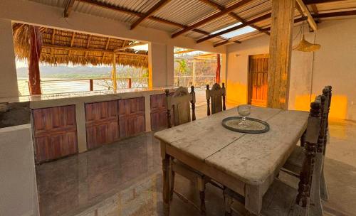 a kitchen with a wooden table with a wine glass on it at Casa Costa Salvaje in El Gigante