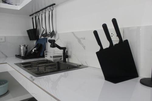 a kitchen counter with a sink and utensils at Boracay Luxury Apartments in Boracay