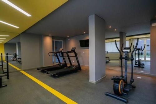 a gym with several tread machines in a room at Apto Moderno e Acolhedor in Sao Paulo