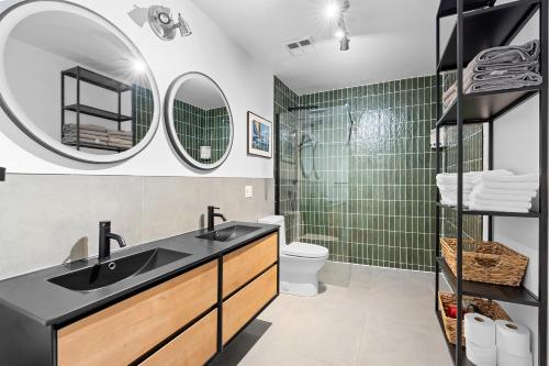 a bathroom with a sink and a shower with green tiles at The redbull lodge with parking in Quebec City