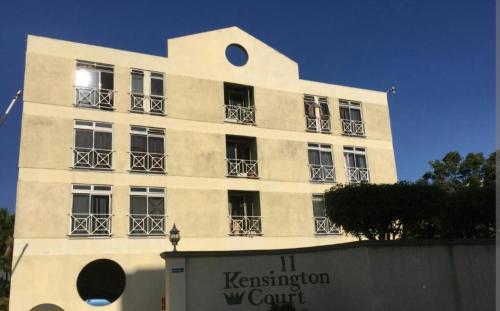 a white building with balconies on the side of it at JAMI PLACE New Kingston in Kingston