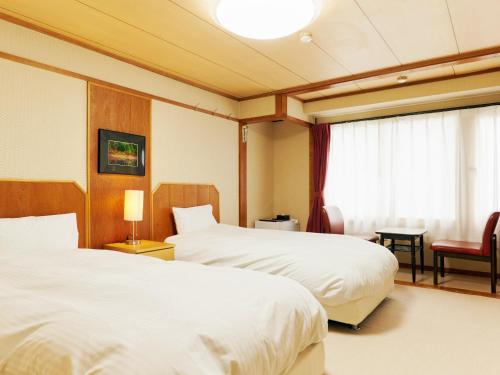 Ένα ή περισσότερα κρεβάτια σε δωμάτιο στο Ishinoyu Lodge