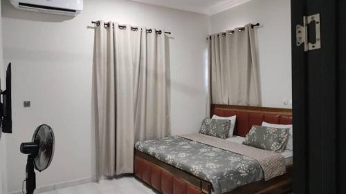 a small bedroom with a bed with a window at lewis & lawrenda (ddt) in Haatso