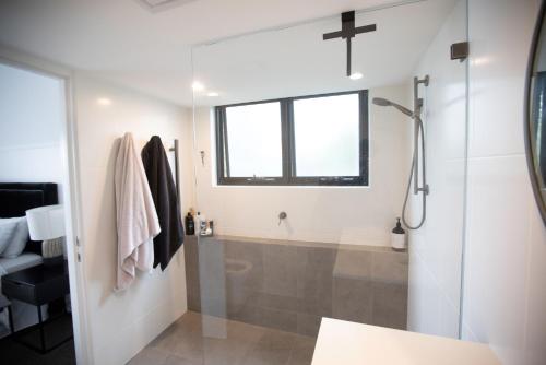 a bathroom with a shower and a bath tub at PHOE1-3B - Harbour Haven Townhouse in Sydney