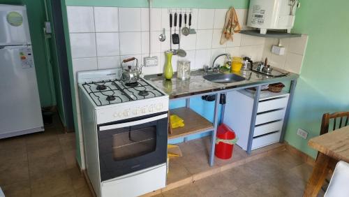 a kitchen with a stove and a sink at Departamento El Membrillo in Valle