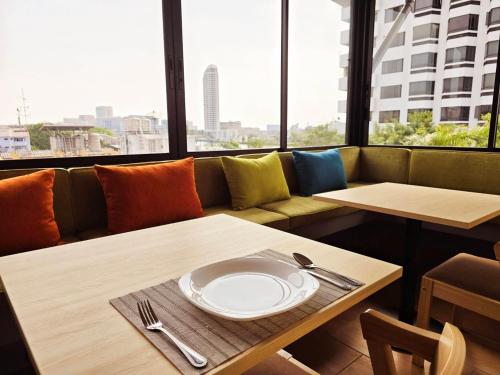 a dining room with a plate on a table at Red Door Samsen Hotel, Bangkok in Bangkok
