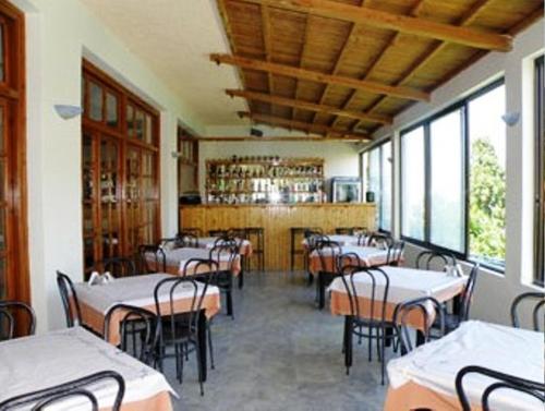 a restaurant with tables and chairs in a room at Hotel Kavouris in Skopelos Town
