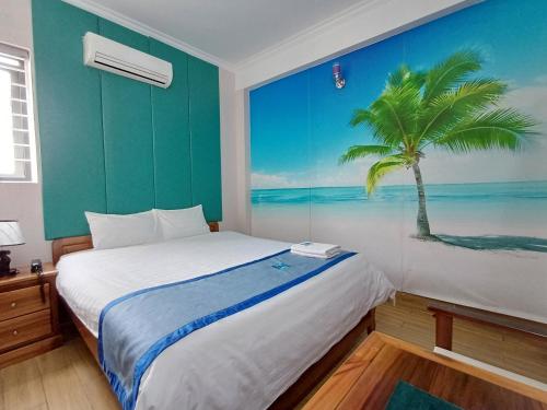 a bedroom with a bed with a palm tree mural at Hotel Lê My in Can Tho