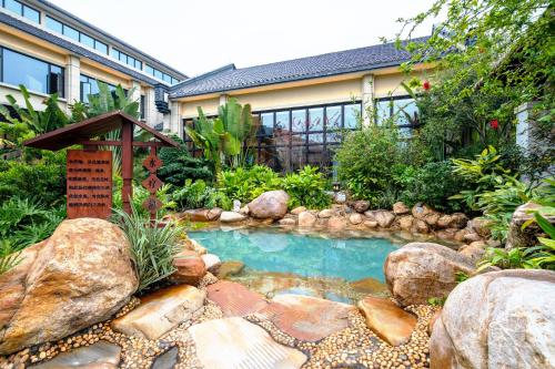 a small pool in the middle of a garden at 从化方圆·云雅酒店 in Guangzhou