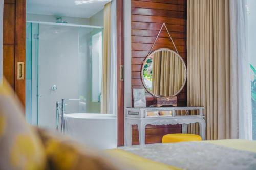 un baño con lavabo y espejo en Anari Villas Kuta, en Legian