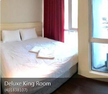 a bedroom with a white bed with a window at Hotel18 in Ipoh