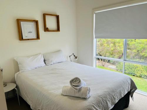 a bedroom with a bed with a towel on it at Salt Life - Pet Friendly Outside WIFI in Robe