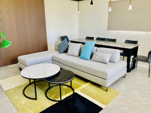 a living room with a couch and a table at Beachcastle & Sea View Villa in Magong