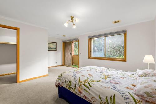 a bedroom with a bed and a window at Simpson Getaway 4 in Point Lonsdale