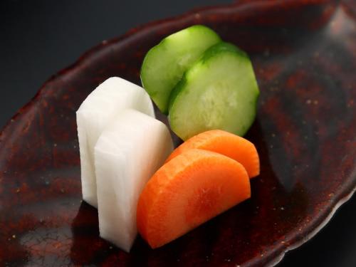 a plate of food with cheese and vegetables on it at Takanoya in Yuzawa