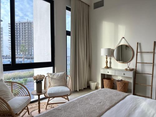 a bedroom with a bed and a large window at Wishes Luxury villa near to beach in Ras al Khaimah