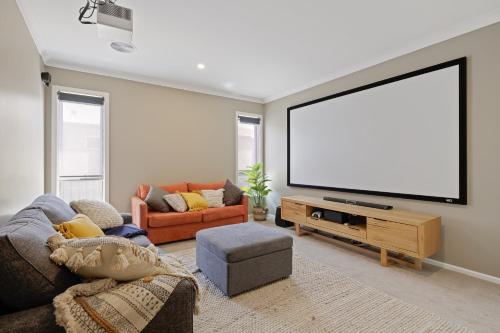 a living room with a large flat screen tv at Cowes Family Beach House in Cowes