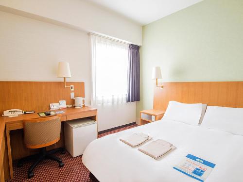 Postel nebo postele na pokoji v ubytování Hearton Hotel Shinsaibashi
