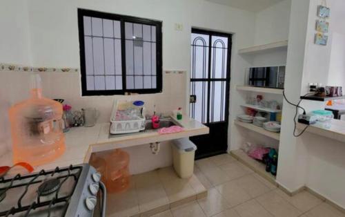 a kitchen with a stove and a counter top at Casa Nuevo México in Mérida
