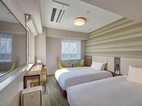 Postel nebo postele na pokoji v ubytování Hearton Hotel Shinsaibashi Nagahoridouri