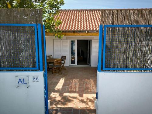 an open gate to a house with a patio at 26 Casa dos Miúdos - Alfarim in Sesimbra