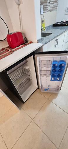 an open refrigerator with its door open in a kitchen at FLORIDA Apartment in Buenos Aires
