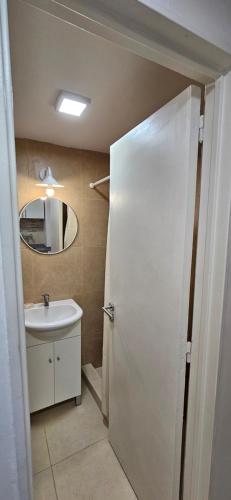 a bathroom with a white sink and a mirror at FLORIDA Apartment in Buenos Aires