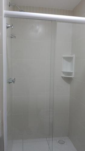 a shower with a glass door in a bathroom at Golden Lake Apart Hotel Arraial do Cabo RJ A&J 2 in Arraial do Cabo