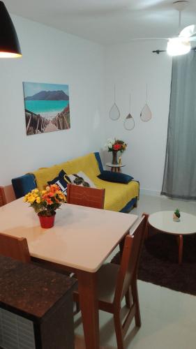 a living room with a table and a couch at Golden Lake Apart Hotel Arraial do Cabo RJ A&J 2 in Arraial do Cabo