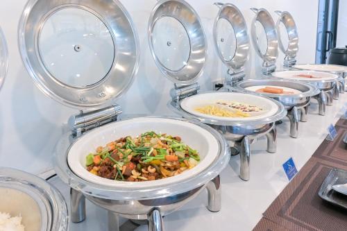 a row of bowls of food on a table at Shewin de Bangkok in Ban Bang Bamru