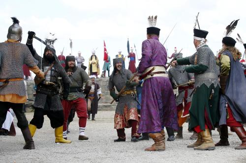 a group of men dressed in historical costumes standing around at Nemes Apartman in Eger