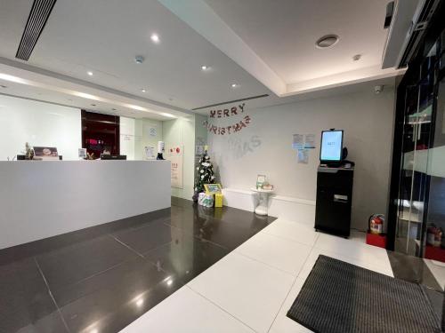 a lobby of a store with a christmas tree on the wall at CHECK inn Express Taipei Yongkang in Taipei