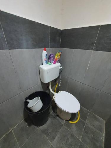 a small bathroom with a toilet and a sink at Taman Limauan Kinarut in Kinarut