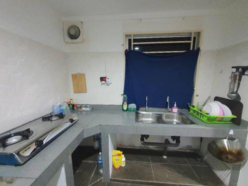 a kitchen with a sink and a counter top at Taman Limauan Kinarut in Kinarut