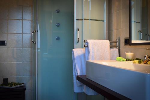 a bathroom with a tub and a sink and a shower at B&B Terrazza dell'Etna in Mascalucia
