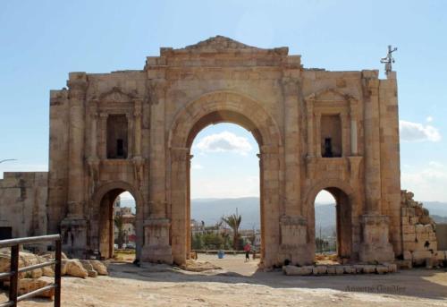an ancient building with two archways with a cross at Ruins Hotel Jerash in Jerash