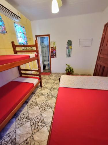 a room with two bunk beds and a window at Jurema Hostel in Itacaré