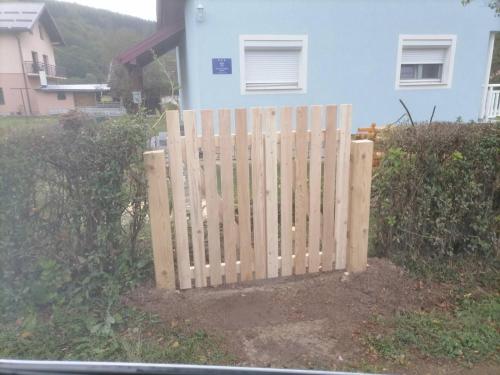 a wooden fence in front of a house at HOLIDAY HOUSE MARIC 