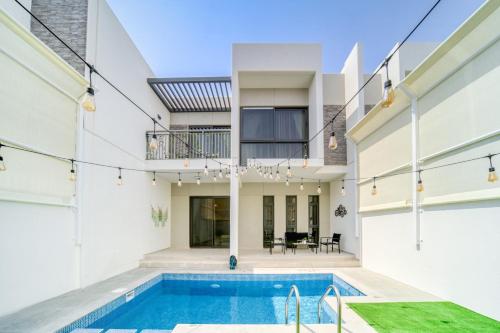 an exterior view of a house with a swimming pool at Damac Hills ll - 4 bedrooms House with Private Pool at Dubai Land in Dubai