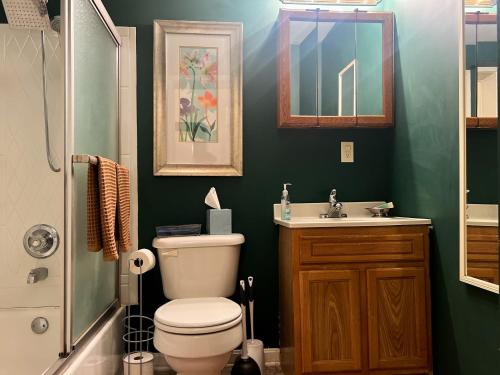 a bathroom with a toilet and a sink at Mon Fournissuer 4bd Home with backyard in Louisville