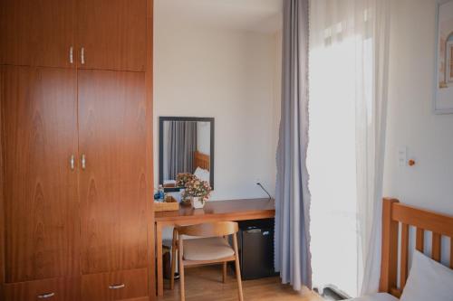 a bedroom with a wooden desk and a mirror at SEN VILLA Boutique in Bao Loc