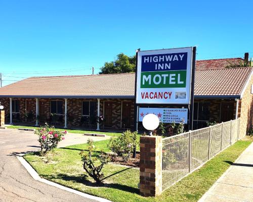 a high way inn motel sign in front of a building at Highway Inn Motel in Hay