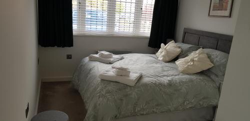 - une chambre avec un lit et des serviettes dans l'établissement Greenway, à Ollerton